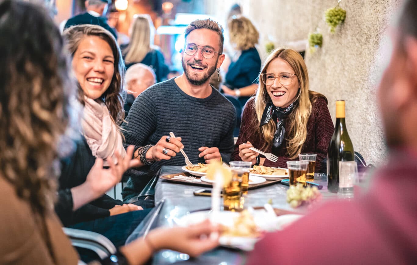 Young,Friends,Having,Fun,Drinking,White,Wine,At,Street,Food