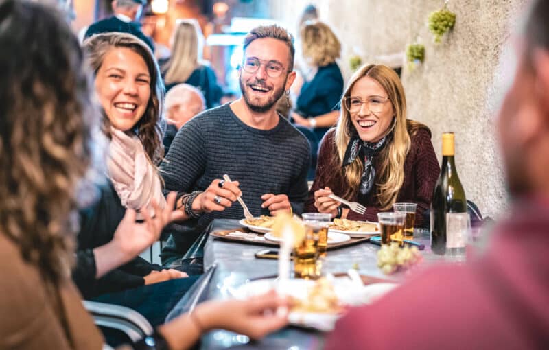 Young,Friends,Having,Fun,Drinking,White,Wine,At,Street,Food